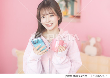 A young woman operating a smartphone A young woman operating a smartphone 139065906