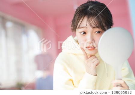 A young woman suffering from skin problems A young woman suffering from skin problems 139065952