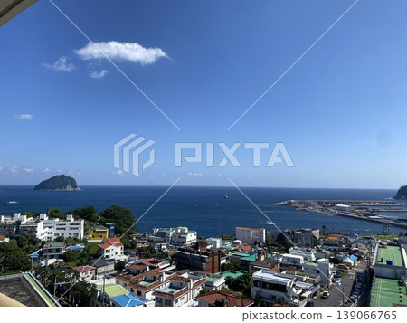 The sea and colorful town as seen from a hilltop The sea and colorful town as seen from a hilltop 139066765