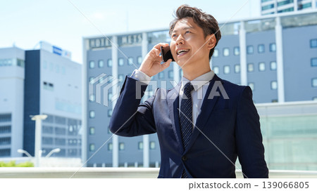 Male businessman talking on a smartphone Male businessman talking on a smartphone 139066805