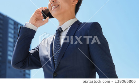 Male businessman talking on a smartphone Male businessman talking on a smartphone 139066806