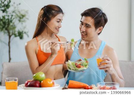 Fit couple enjoys healthy fruit breakfast after yoga training. fitness, nutrition, home lifestyle. Fit couple enjoys healthy fruit breakfast after yoga training. fitness, nutrition, home lifestyle. 139066966