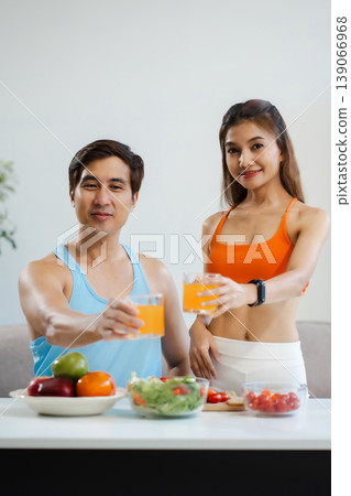 Fit couple enjoys healthy fruit breakfast after yoga training. fitness, nutrition, home lifestyle. 139066968