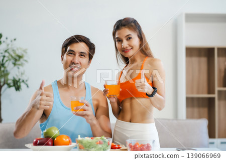 Fit couple enjoys healthy fruit breakfast after yoga training. fitness, nutrition, home lifestyle. Fit couple enjoys healthy fruit breakfast after yoga training. fitness, nutrition, home lifestyle. 139066969