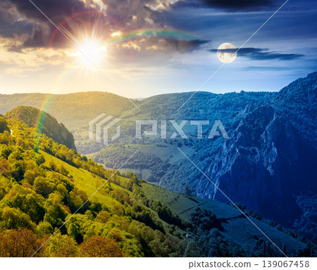 beautiful countryside. day meet night. sun and moon over wonderful springtime landscape in mountains. grassy field and rolling hills. rural scenery with steep forested slopes. epic highland wallpaper 139067458