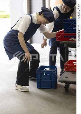 A woman with a sudden backache and knee pain. A woman with a sudden backache and knee pain. 139067636