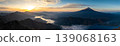 A panoramic photograph of Mount Fuji, Lake Kawaguchi, and Lake Saiko bathed in the morning sun. 139068163