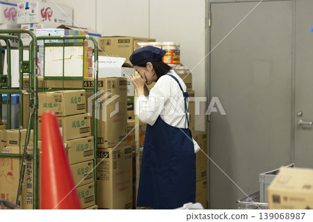 A part-time female worker cries alone in the back room. 139068987