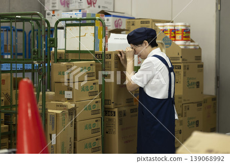 A part-time female worker cries alone in the back room. A part-time female worker cries alone in the back room. 139068992