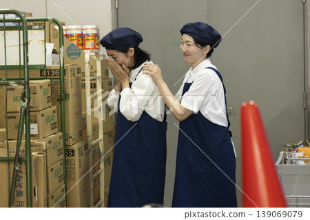 一位同事安慰在後屋哭泣的一位女士。 139069079