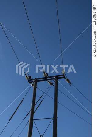 Electric power line pole against clear blue sky Electric power line pole against clear blue sky 139069494