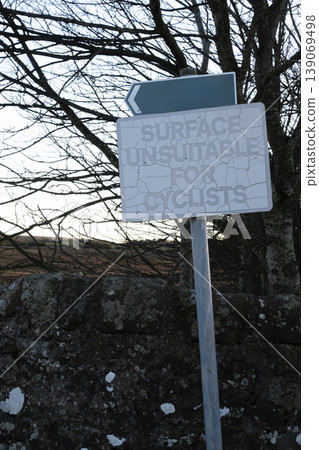 Aged warning sign for cyclists with peeling paint 139069498