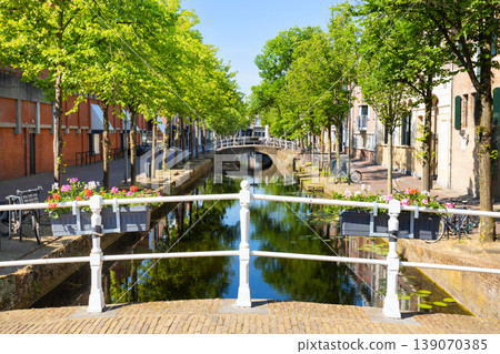 View of the historic canal and houses in Delft city, Netherlands View of the historic canal and houses in Delft city, Netherlands 139070385