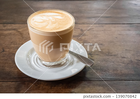 Flat white coffee in cafe on wooden background, top view Flat white coffee in cafe on wooden background, top view 139070842