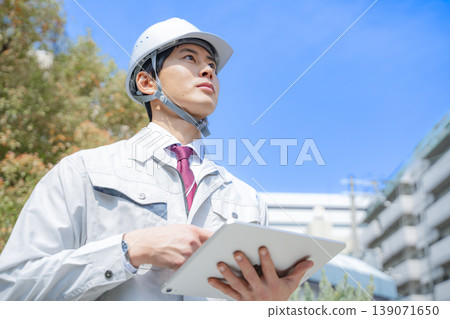 Portrait of a young man in work clothes Portrait of a young man in work clothes 139071650