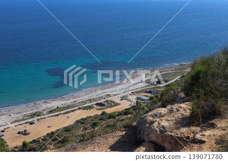 Overhead view of a pristine beach and the calm Mediterranean Sea on a sunny day in Spain. Overhead view of a pristine beach and the calm Mediterranean Sea on a sunny day in Spain. 139071780