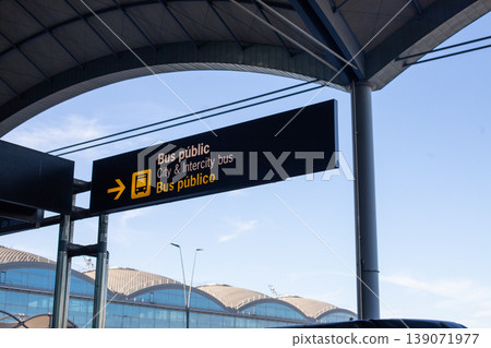 Public bus station sign displaying directions for city and intercity buses, with clear blue sky and modern architecture in the background Public bus station sign displaying directions for city and intercity buses, with clear blue sky and modern architecture in the background 139071977