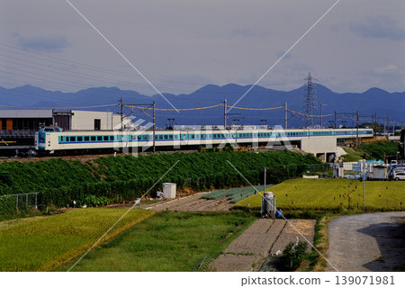 2007: 381 series Limited Express Kuroshio train running on an embankment, in transit. 139071981