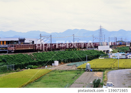 2007: EF8125 container freight train running on an embankment. 2007: EF8125 container freight train running on an embankment. 139071985