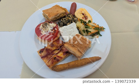 A plate filled with food taken from Greek breakfast buffet A plate filled with food taken from Greek breakfast buffet 139072339