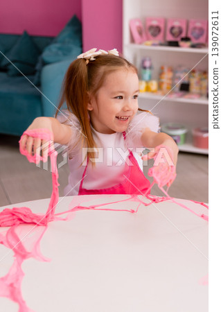 Little girl playing with slime indoors, creative sensory activity for children 139072611