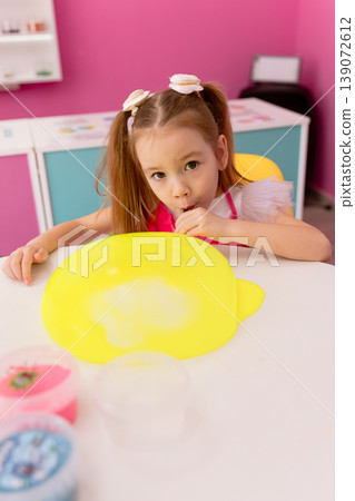 Little girl playing with slime indoors, creative sensory activity for children 139072612