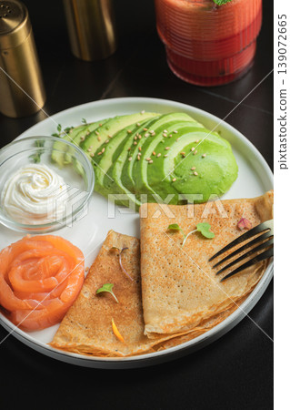Roasted thin pancakes with smoked salmon and sauce 139072665