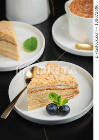 Medovik. Honey cake made from honey cakes with whipped sour cream, decorated with berries, pomegranate and flowers Medovik. Honey cake made from honey cakes with whipped sour cream, decorated with berries, pomegranate and flowers 139072686