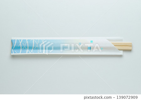 Product photo of disposable chopsticks and chopstick wrappers (light blue) (white background, with space for copy). Product photo of disposable chopsticks and chopstick wrappers (light blue) (white background, with space for copy). 139072909