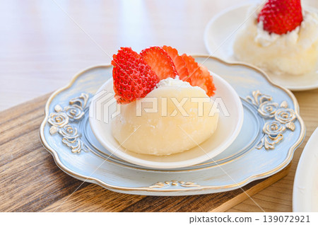 A mochi-style dessert with strawberries and whipped cream. A mochi-style dessert with strawberries and whipped cream. 139072921