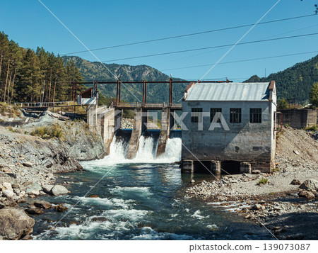 Hydro power plant near a river amidst mountains under a clear blue sky during daytime Hydro power plant near a river amidst mountains under a clear blue sky during daytime 139073087