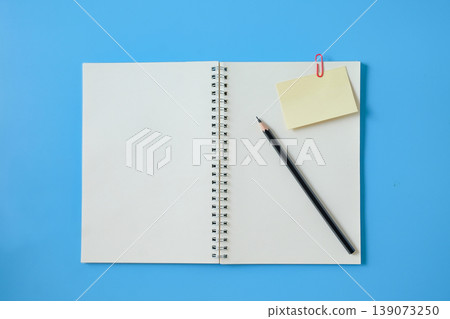 A paper note clipped on notebook for business document updates. A paper note clipped on notebook for business document updates. 139073250