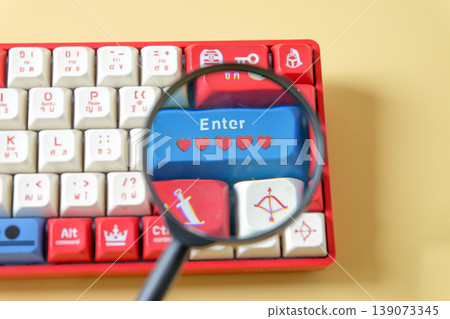 A magnifying glass on keyboard gamer,Internet search concept. A magnifying glass on keyboard gamer,Internet search concept. 139073345