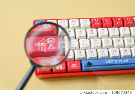 A magnifying glass on keyboard gamer,Internet search concept. A magnifying glass on keyboard gamer,Internet search concept. 139073346
