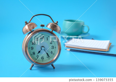 Vintage alarm clock with coffee cup and note. Vintage alarm clock with coffee cup and note. 139073355