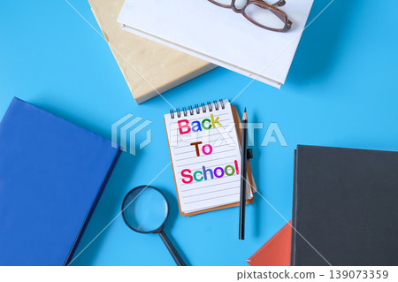A book note with pen and hard cover books,Back to school concept. A book note with pen and hard cover books,Back to school concept. 139073359