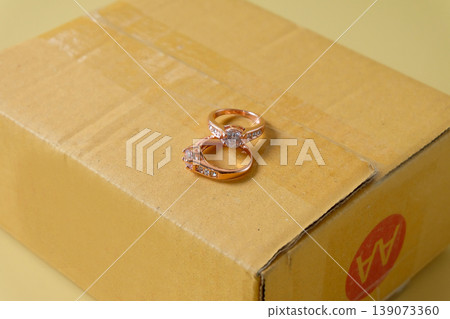 Duo golden wedding ring on paper box on background. Duo golden wedding ring on paper box on background. 139073360