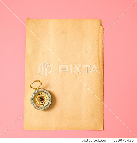 Old paper with vintage compass on color background. Old paper with vintage compass on color background. 139073436