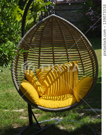 yellow padded swing seat in the garden 139073558