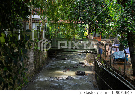 Urban Canal with Bridge and Natural Shade from Trees 139073640