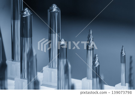 Close-up of a high-precision taper flat nose end mill tool in a modern industrial setting. Close-up of a high-precision taper flat nose end mill tool in a modern industrial setting. 139073798