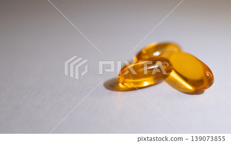 Very close-up of soft capsules of vitamins on white background. Very close-up of soft capsules of vitamins on white background. 139073855