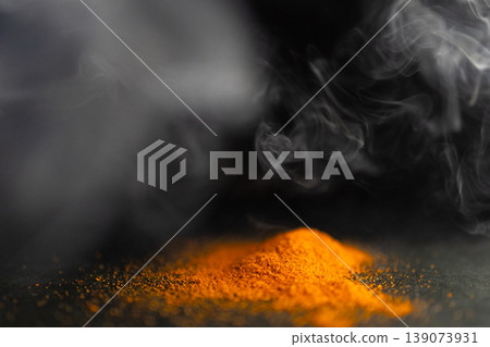 Horizontal picture of pile of red parika with smoke around it.Black background Horizontal picture of pile of red parika with smoke around it.Black background 139073931