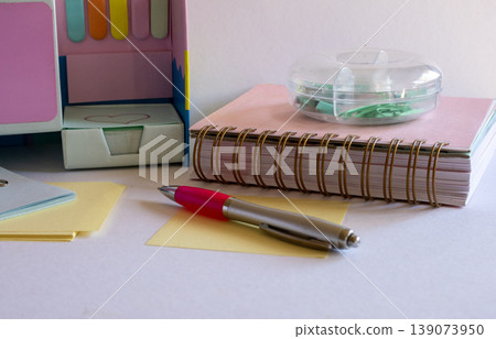 Modern office stationery arranged on a bright desk, depicting organization, planning, and everyday work tasks for students, freelancers, and small business owners Modern office stationery arranged on a bright desk, depicting organization, planning, and everyday work tasks for students, freelancers, and small business owners 139073950