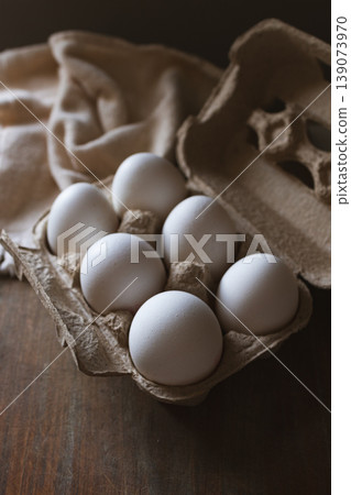 White chicken eggs filling a recyclable cardboard carton, symbolizing healthy eating on national egg day White chicken eggs filling a recyclable cardboard carton, symbolizing healthy eating on national egg day 139073970