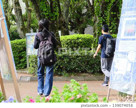 University students walking down a tree-lined street University students walking down a tree-lined street 139074058