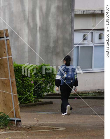 University students walking down a tree-lined street 139074077