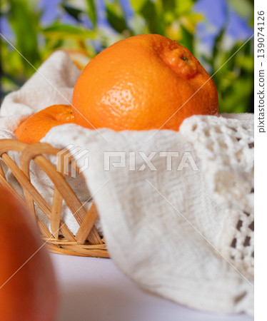 Fresh mandarins fruits in a basket with garden background 139074126