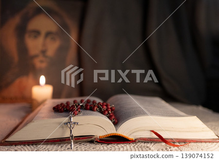 Horizontal photo of a Catholic table with The Bible and a Rosary. Horizontal photo of a Catholic table with The Bible and a Rosary. 139074152