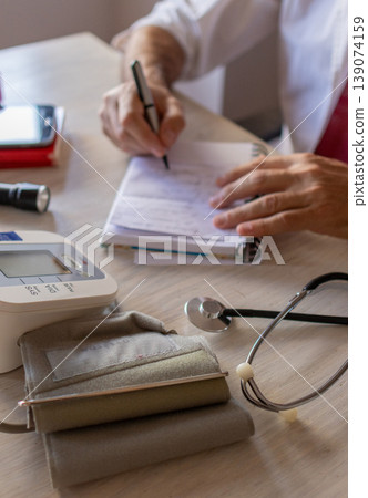 Medical equipment for blood pressure care in the foreground. 139074159